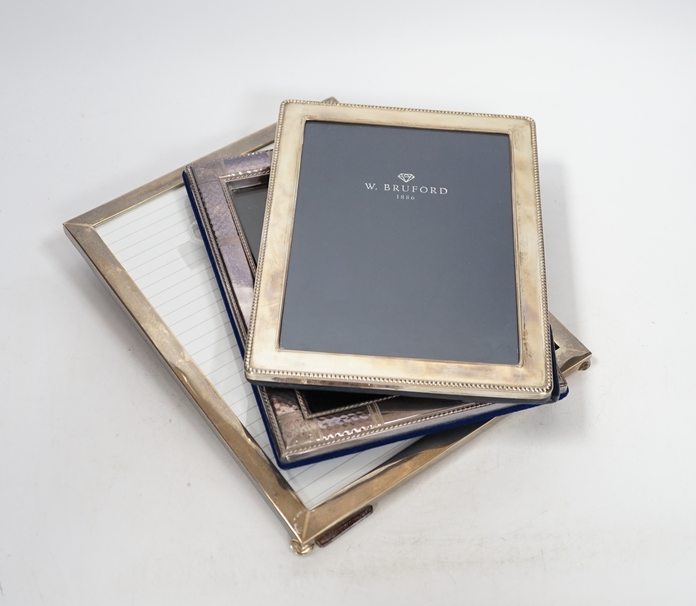 Two modern sterling silver mounted photograph frames, 21cm and a larger unmarked frame, 25cm